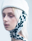 NOOR - Structured faux-sheepskin pillbox hat with jersey ties