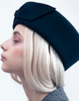 JACKIE - 1960s-style pillbox hat in black wool.