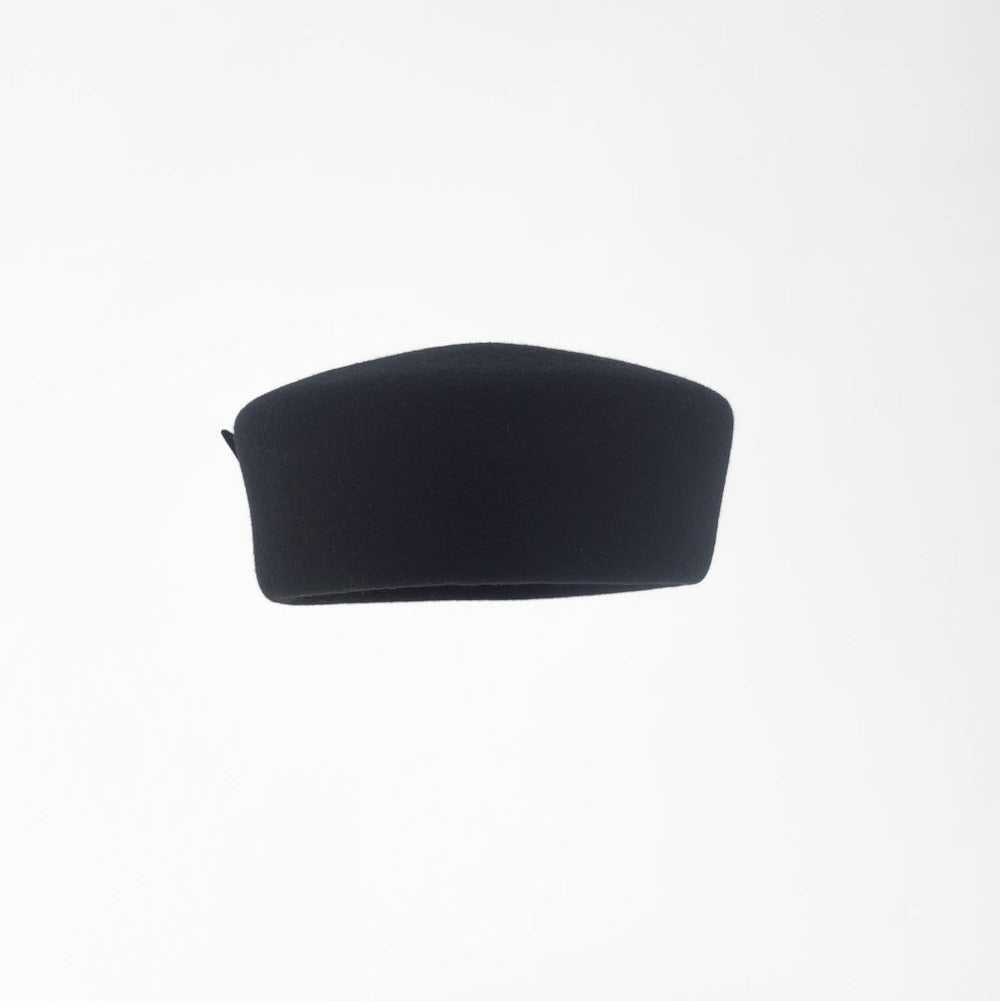 JACKIE - 1960s-style pillbox hat in black wool.