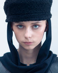 NOOR - Structured faux-sheepskin pillbox hat with jersey ties