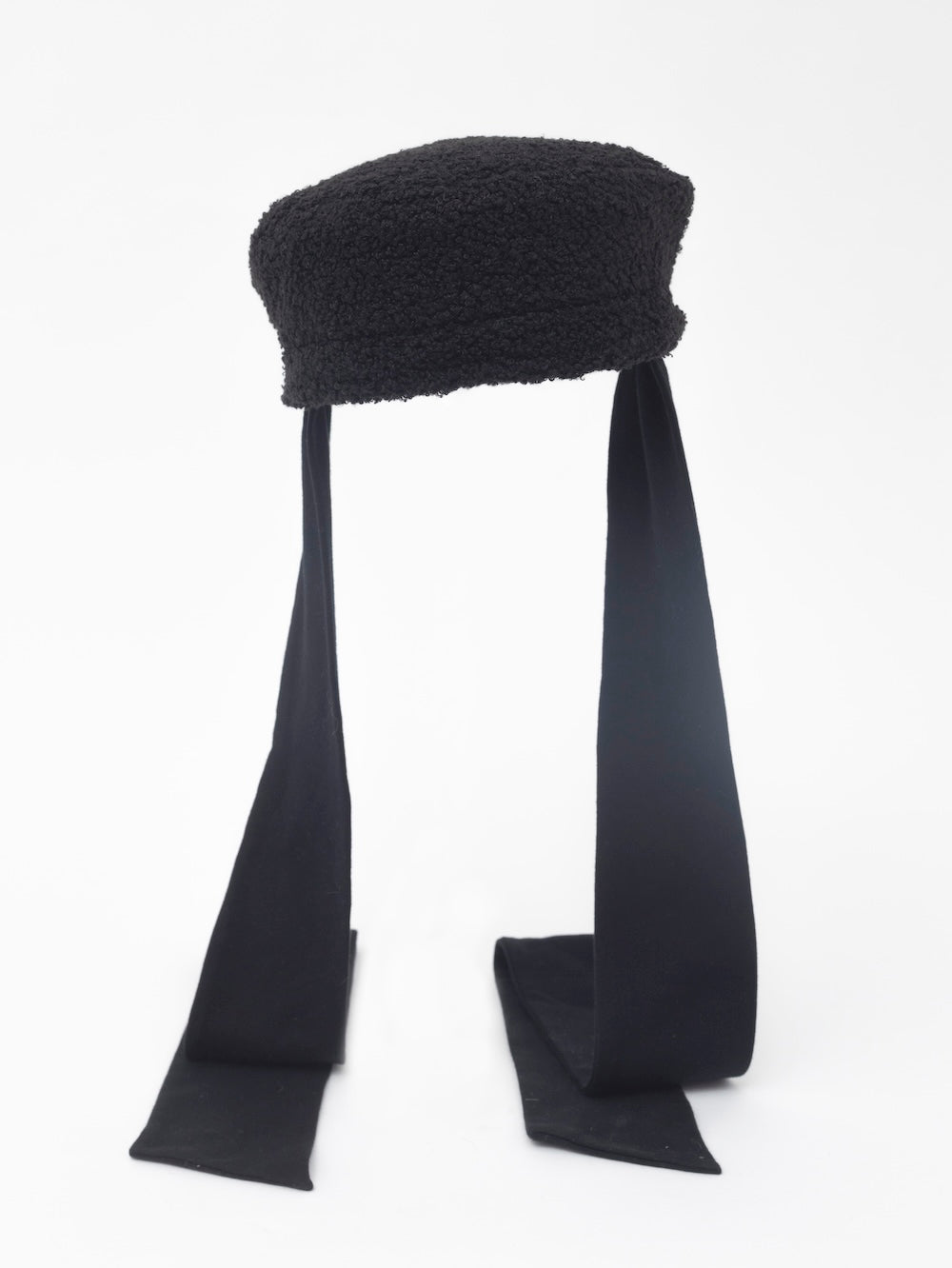 NOOR - Structured faux-sheepskin pillbox hat with jersey ties