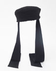 NOOR - Structured faux-sheepskin pillbox hat with jersey ties
