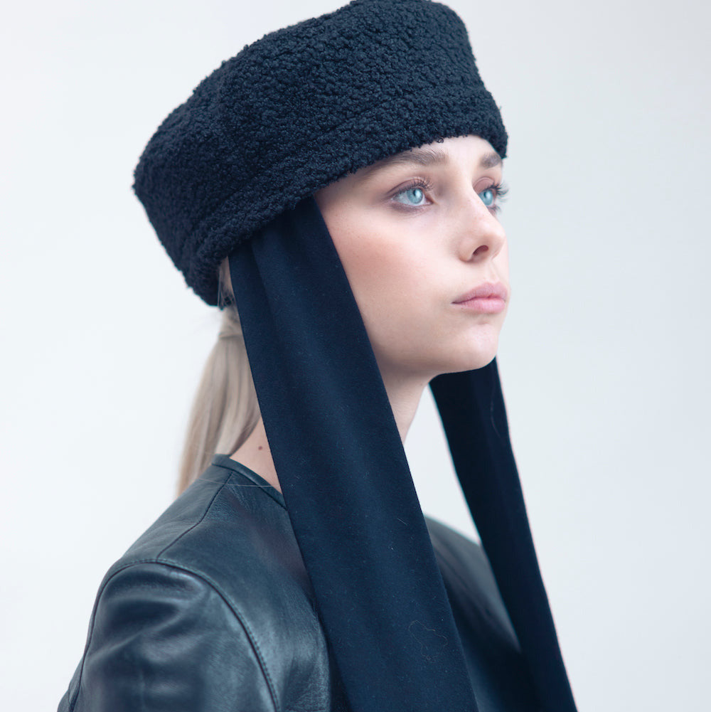 NOOR - Structured faux-sheepskin pillbox hat with jersey ties