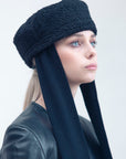 NOOR - Structured faux-sheepskin pillbox hat with jersey ties