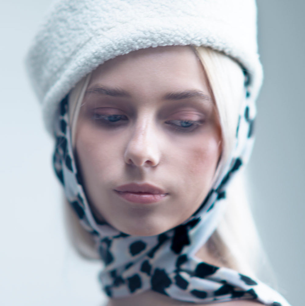 NOOR - Structured faux-sheepskin pillbox hat with jersey ties