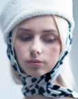 NOOR - Structured faux-sheepskin pillbox hat with jersey ties