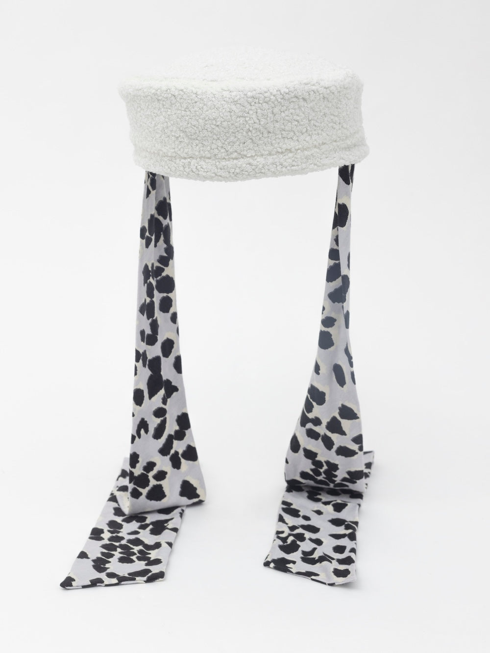 NOOR - Structured faux-sheepskin pillbox hat with jersey ties