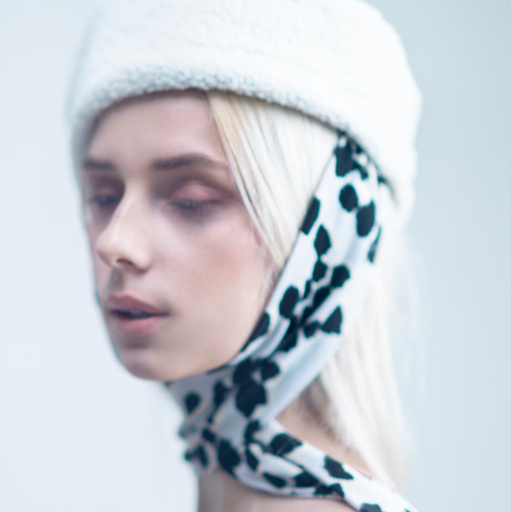NOOR - Structured faux-sheepskin pillbox hat with jersey ties