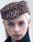 VERONICA - Asymmetric pillbox hat in leoperd-print wool.