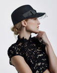 Misa Harada Hats | ALPHA | Porter’s cap in black wool felt with veiled peak and a grosgrain bow
