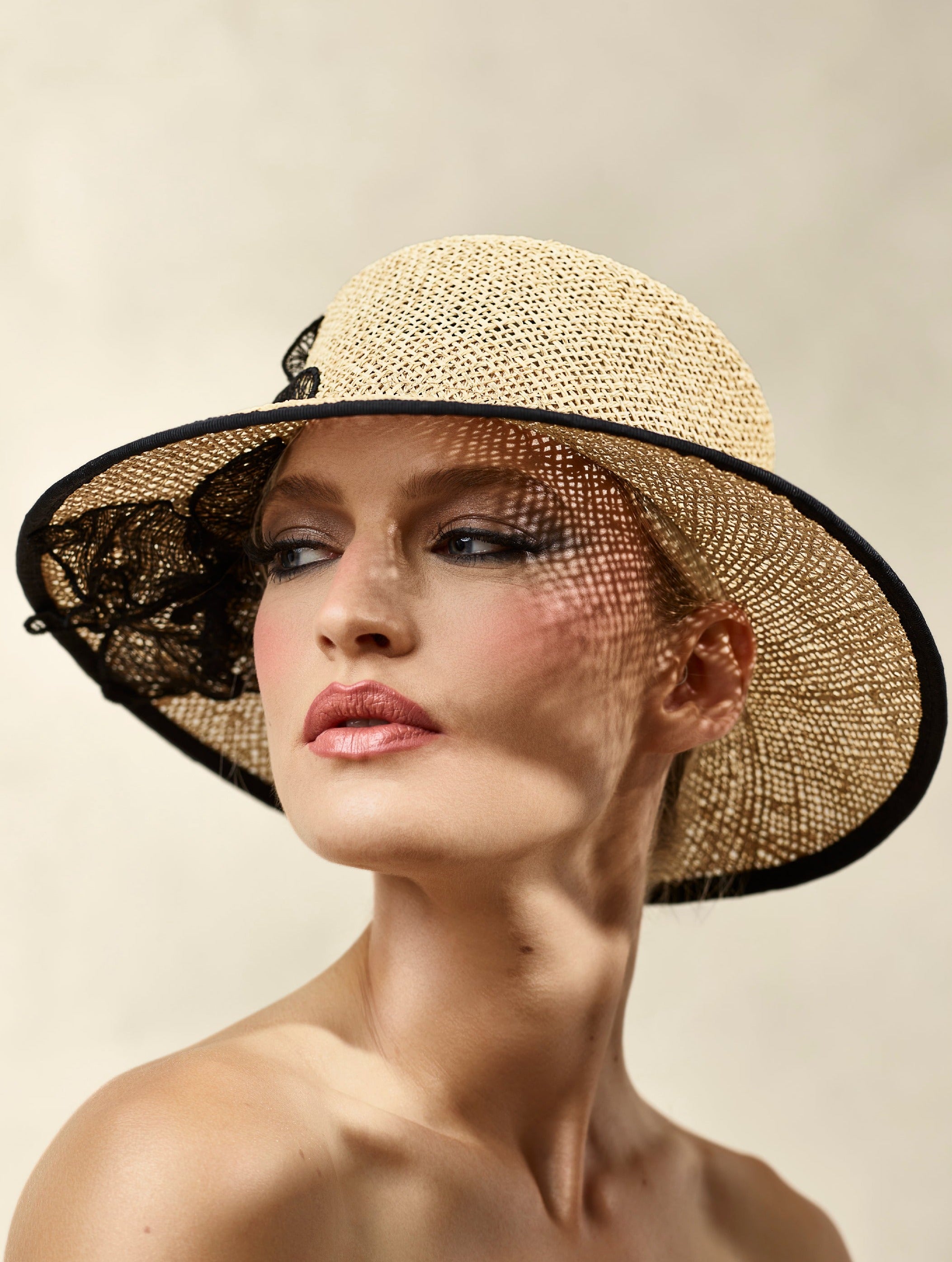 Misa Harada Hats| DAHLIA | Wide-brimmed cloche in natural twisted hessian, with black 3D applique flower over and under brim